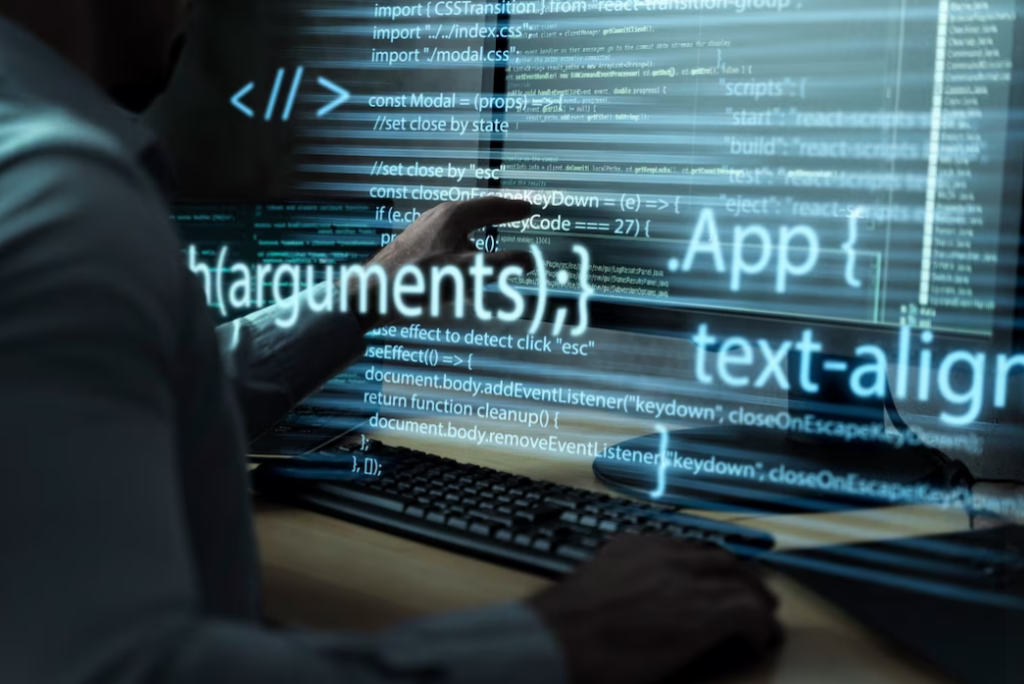 person in shirt sitting at the table and pointing on the screen with code, the background of codes